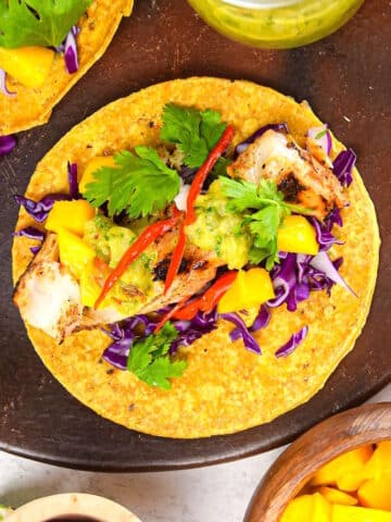 Grilled halibut tacos on brown serving tray.