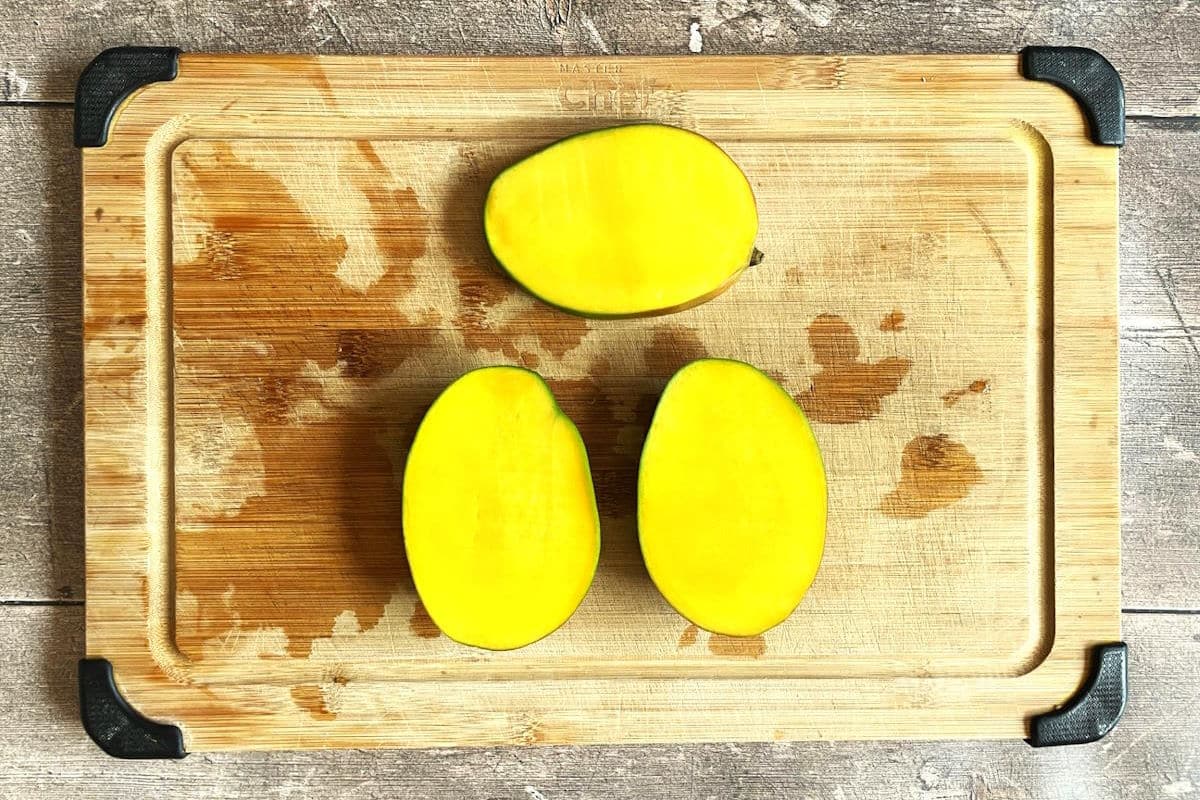 Mango cheeks on cutting board.