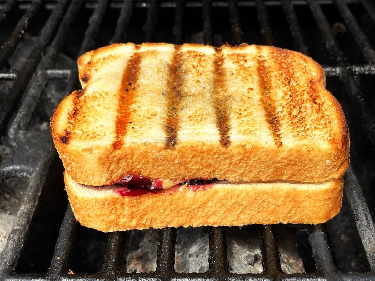 PBJ sandwich on grill with grill marks.