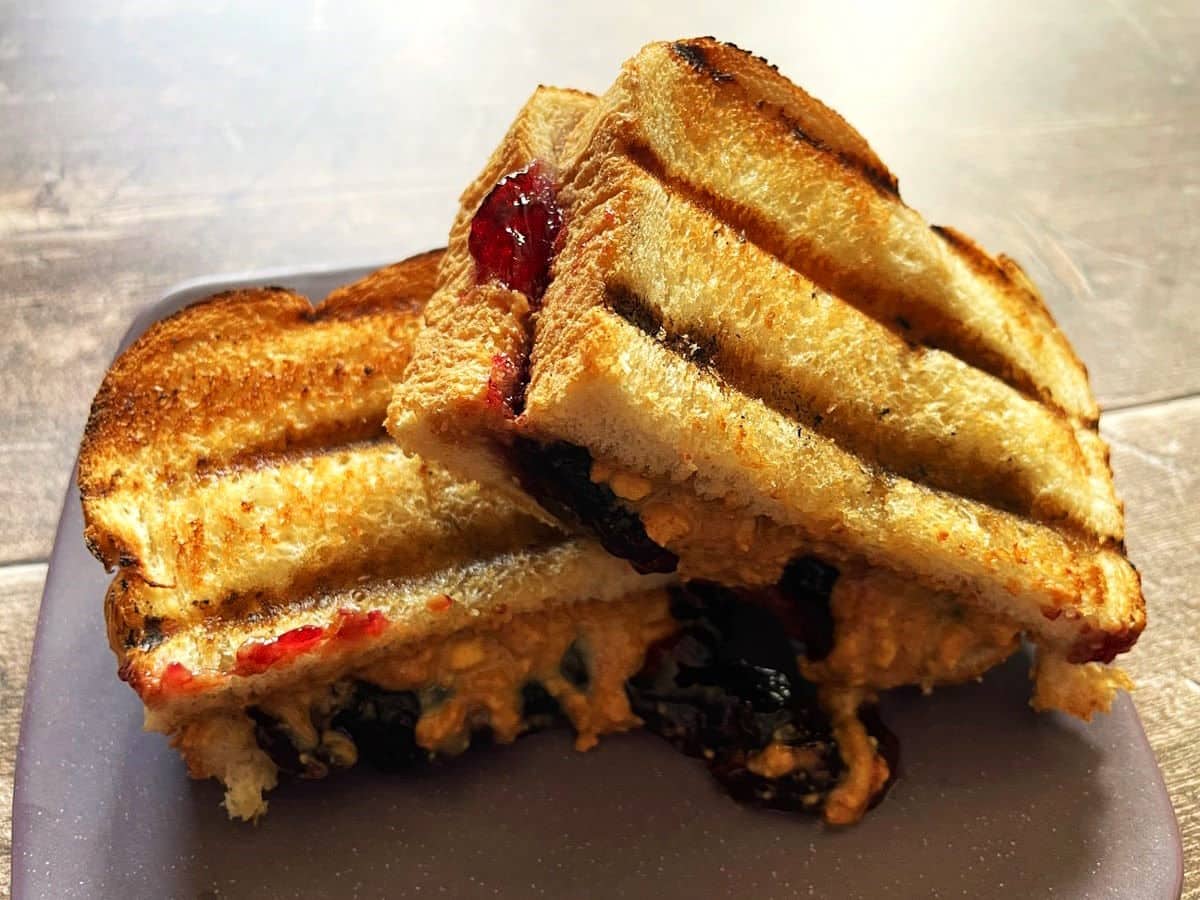 Grilled peanut butter and jelly sandwiches on plate.