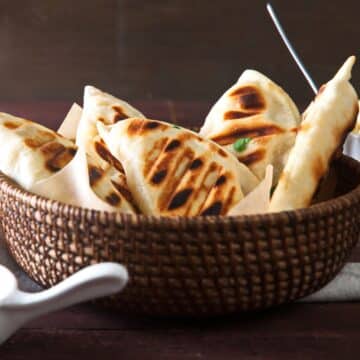 Grilled pierogies in basket.