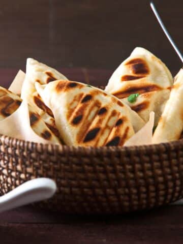 Grilled pierogies in basket.