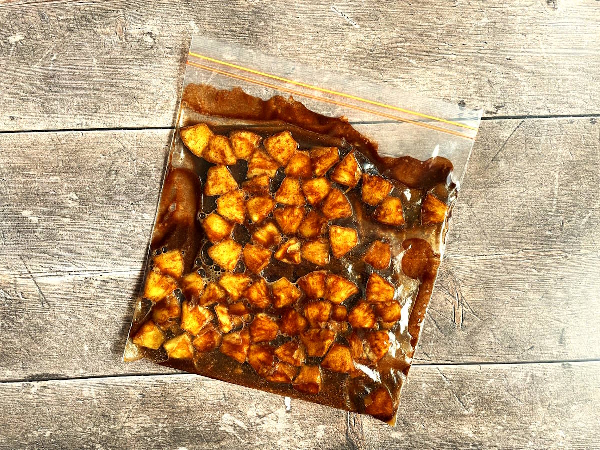 Pineapple wedges in marinade.