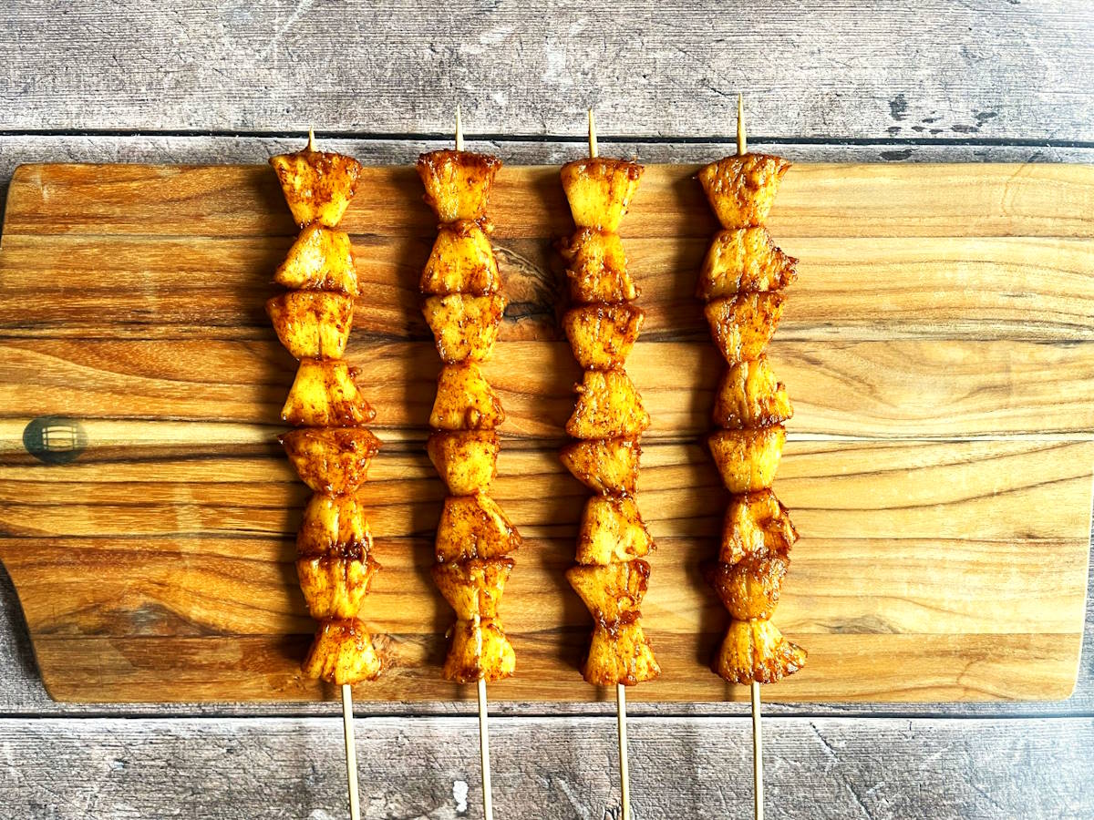 Pineapple wedges on skewers.