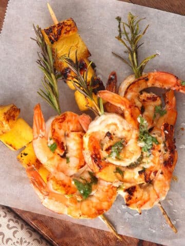Grilled shrimp and pineapple on rosemary skewers.