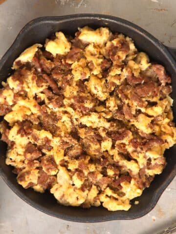 Hamburger scrambled eggs in cast iron pan.