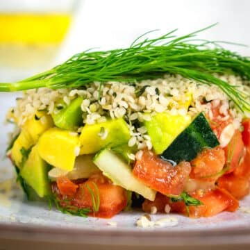 Hemp seed salad stacked on plate.
