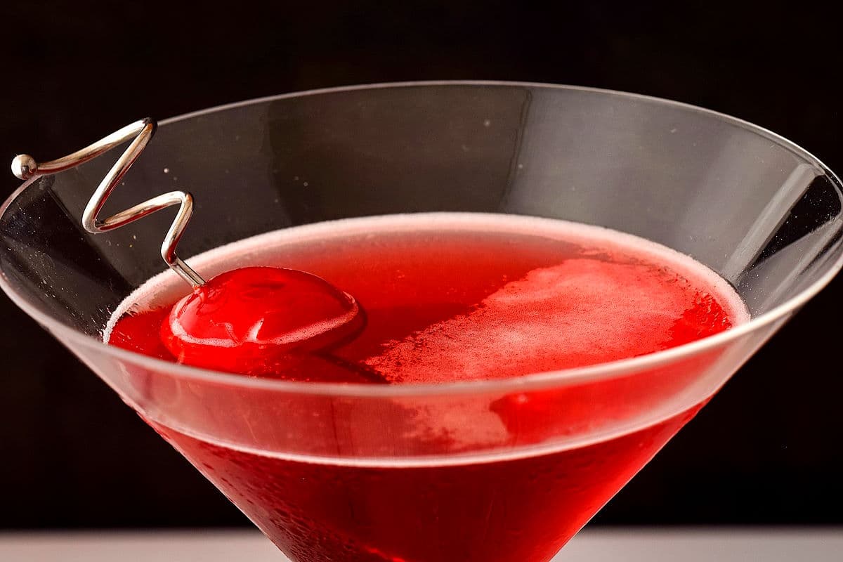 Hibiscus cosmopolitan in martini glass with cherry.