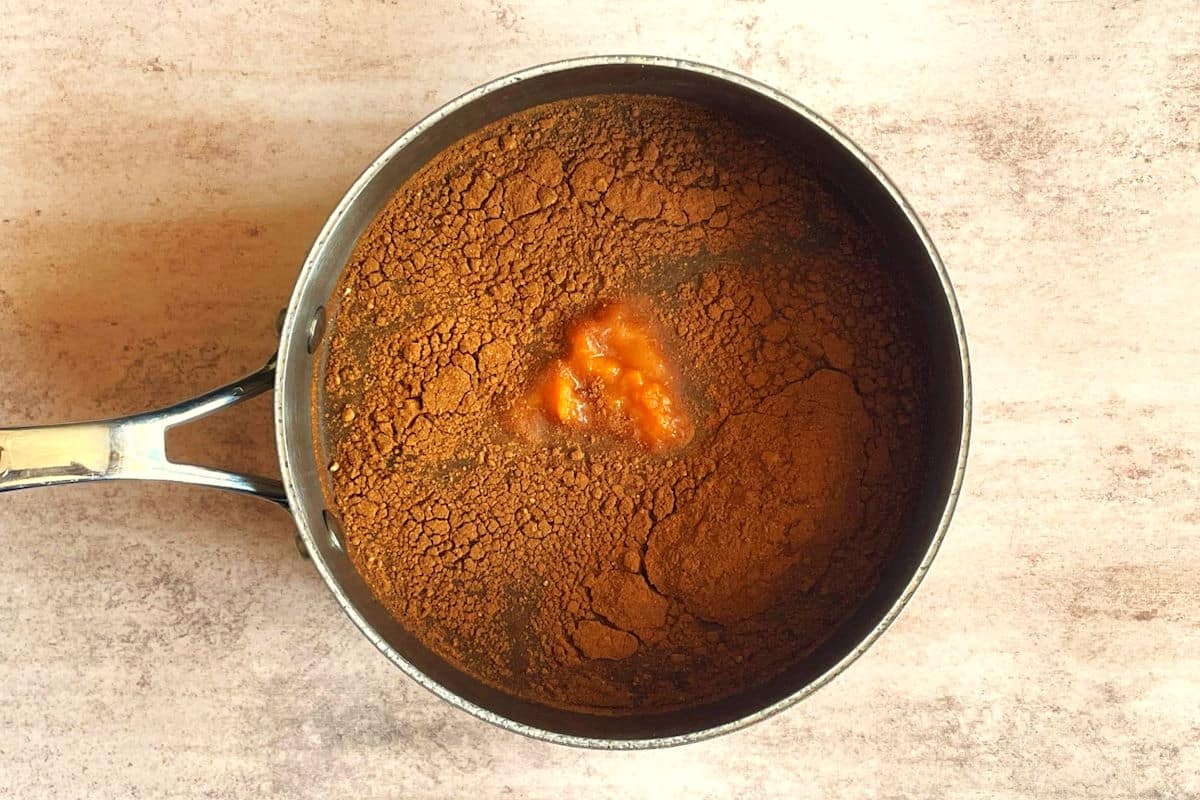 Pumpkin spice syrup ingredients in saucepan.