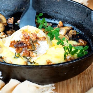 Melted brie cheese in cast iron pan.