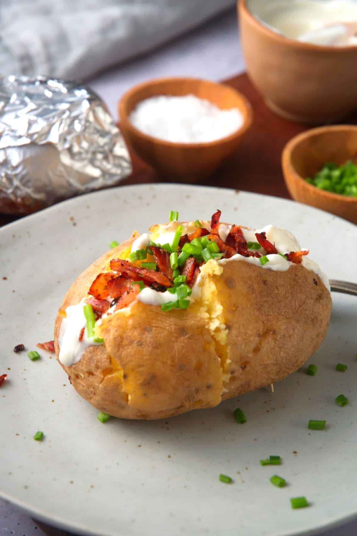 Loaded baked potato on plate.