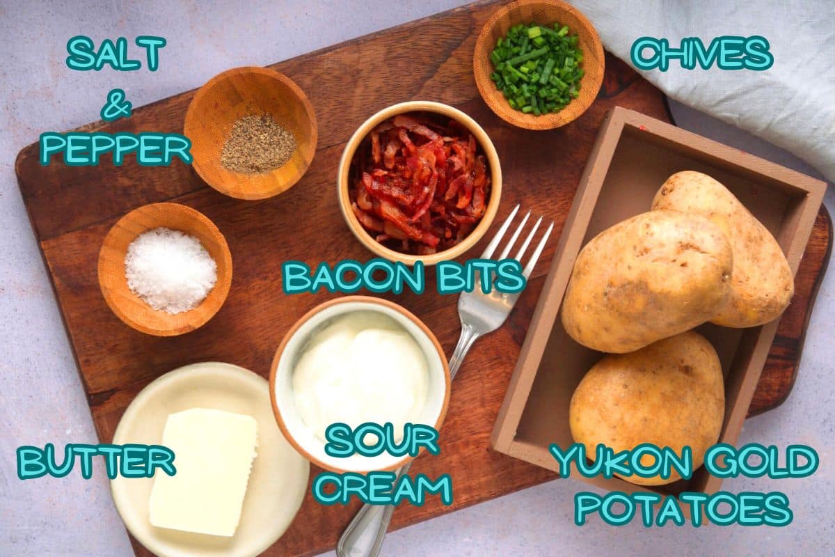 Baked potatoes in foil ingredients prepped on wooden board and labeled.