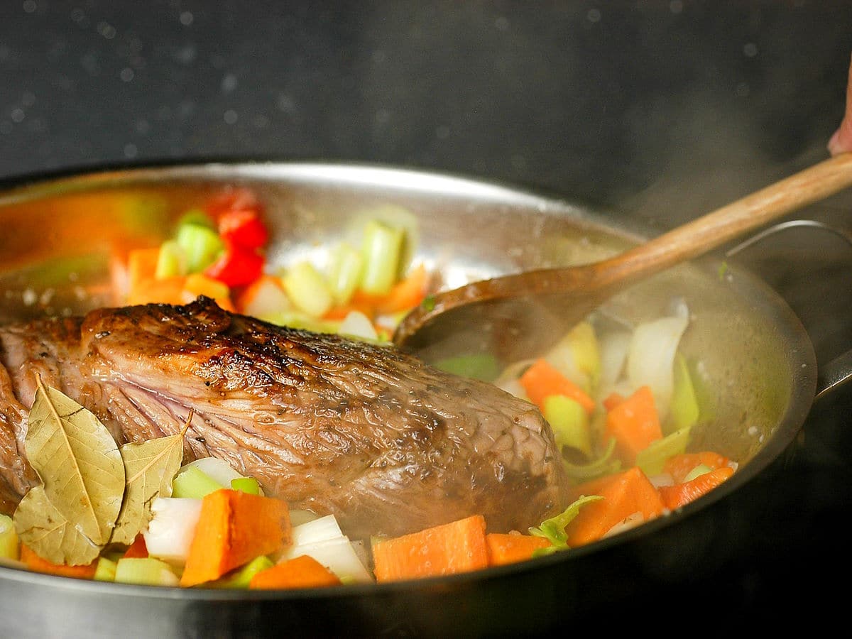 Beef in pan with vegetables.