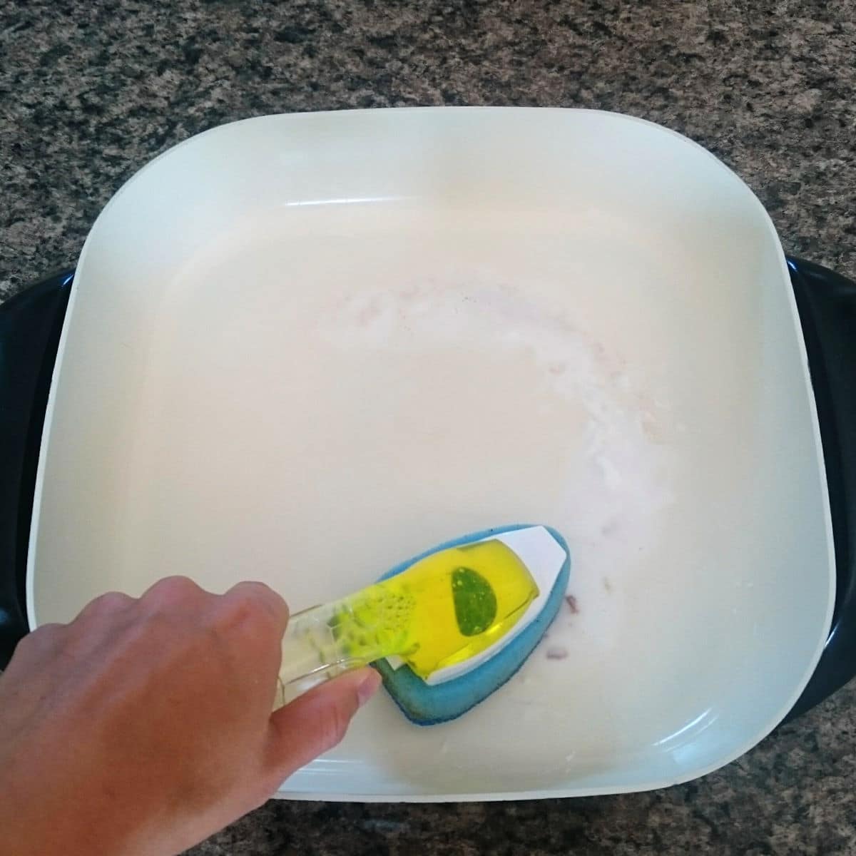 Electric skillet with scrub brush.