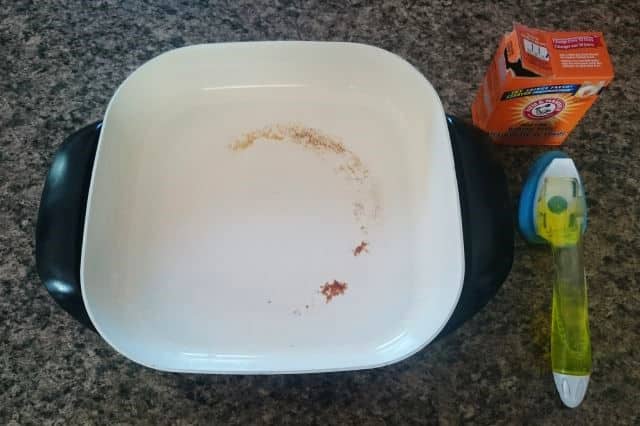 Electric skillet, baking soda and cleaning brush.