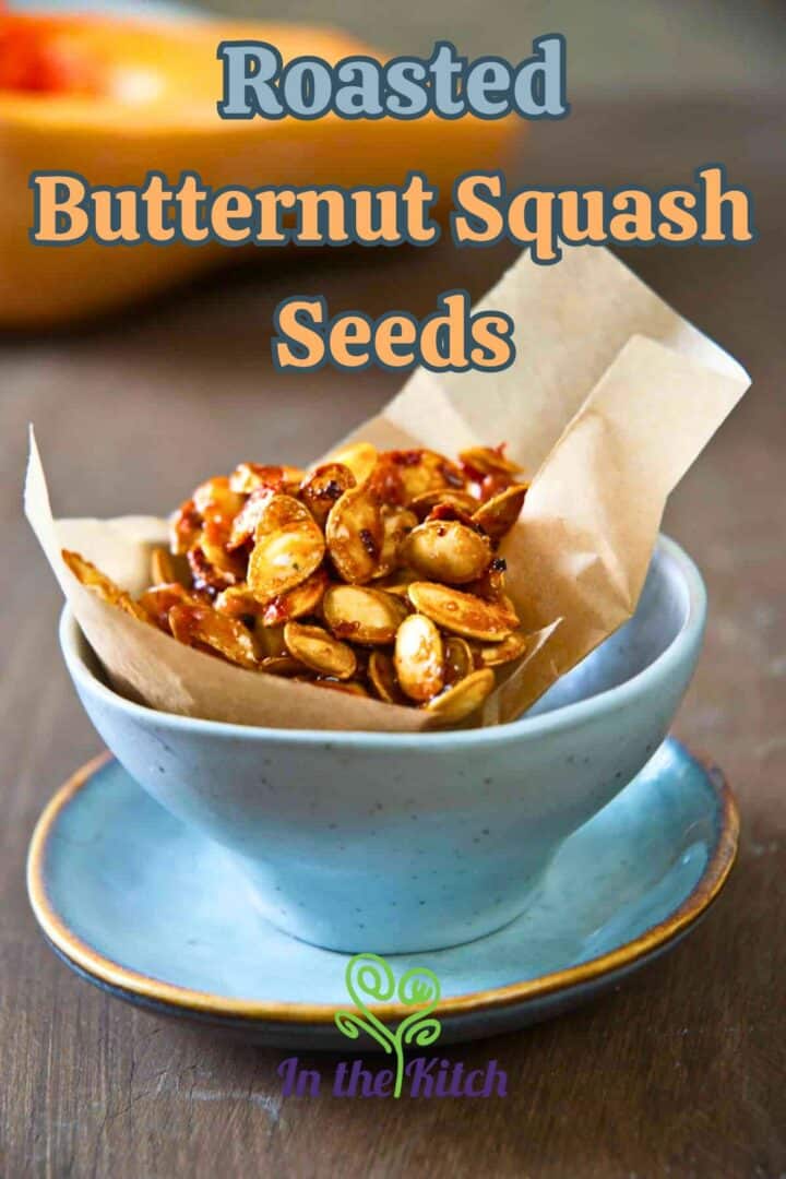 Sweet roasted butternut squash seeds in bowl with text overlay that says 'roasted butternut squash seeds'.