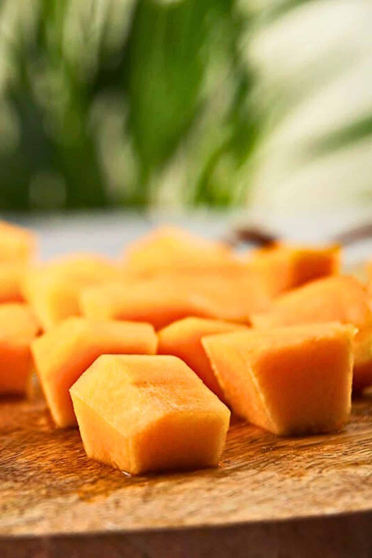 Fresh cantaloupe cubes on board.