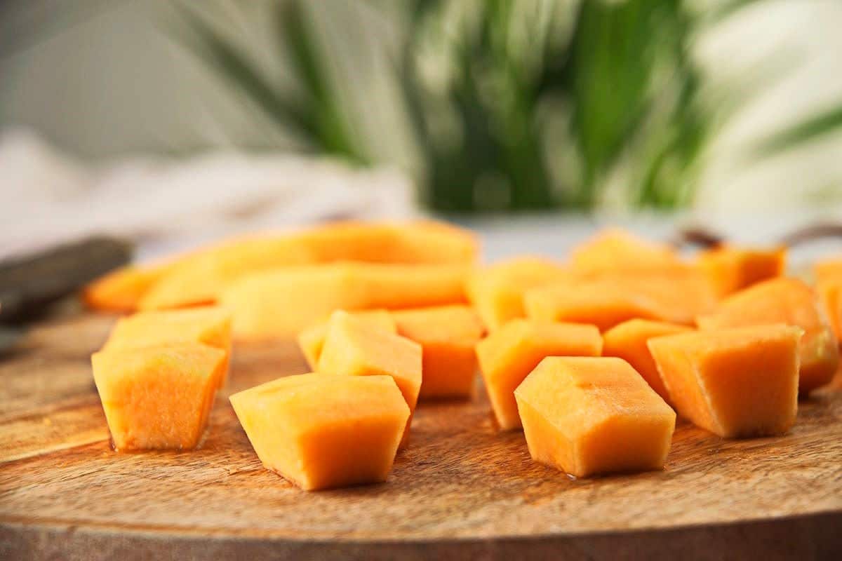Cantaloupe cubes on cutting board.