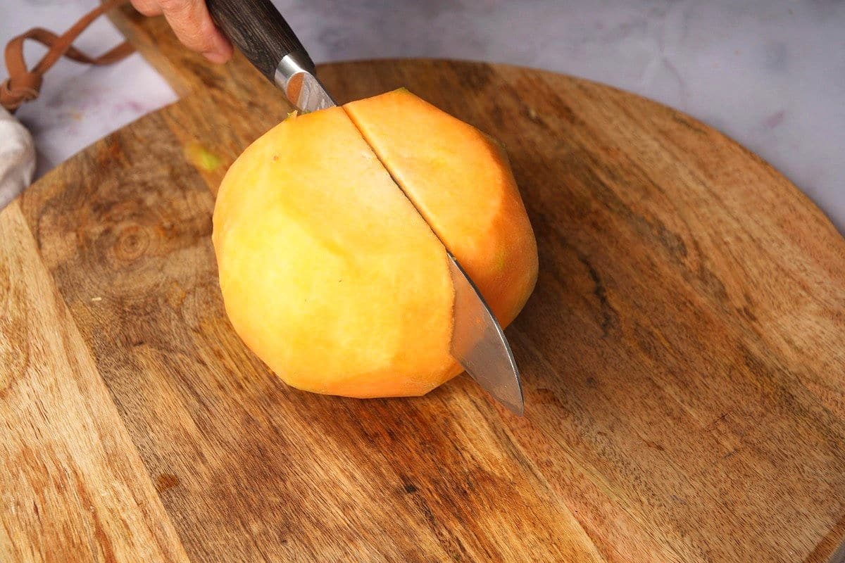 Cantaloupe getting cut in half.