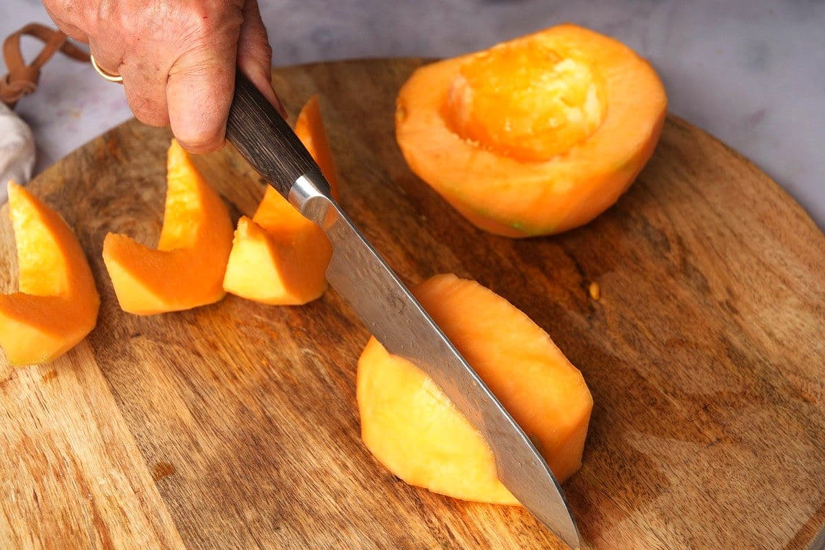 Cantaloupe getting cut into wedges.