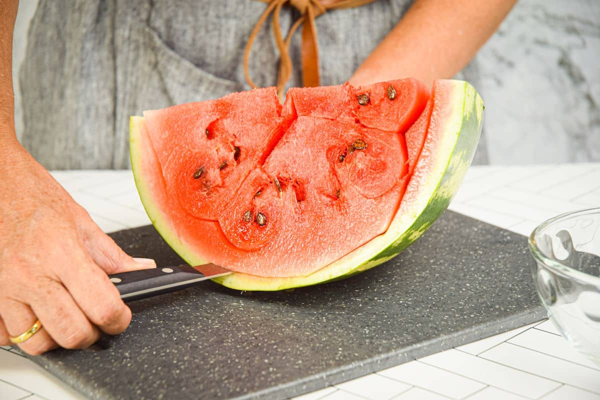 Watermelon getting sliced around the edges.