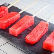Watermelon sticks on black stone.