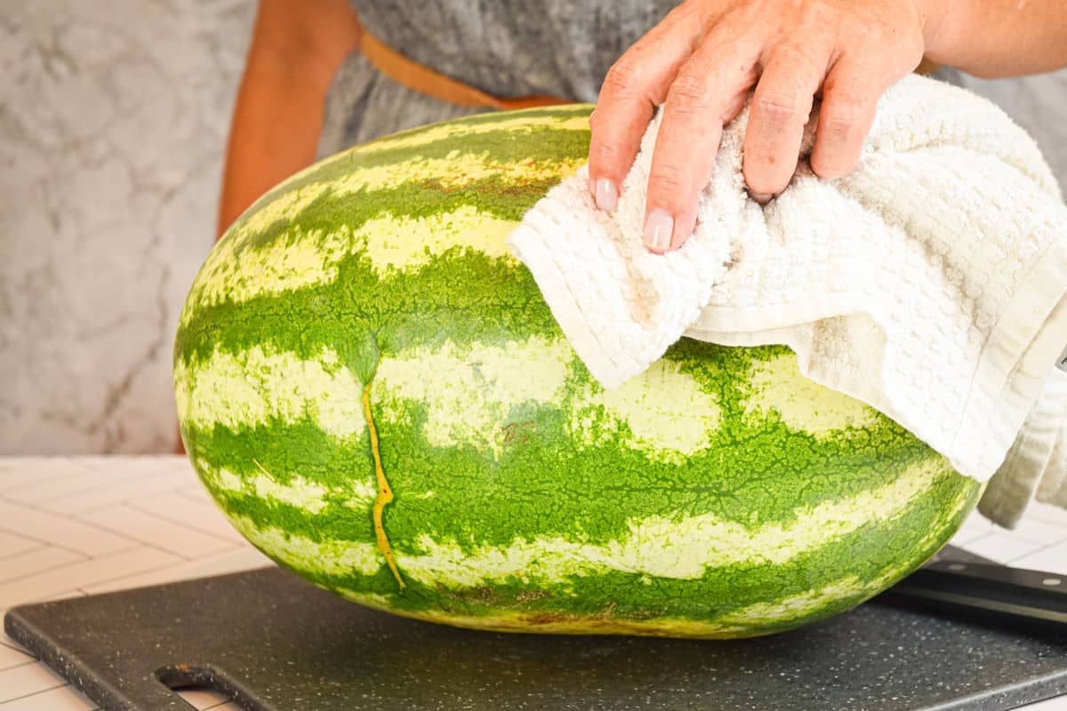 Large watermelon on cutting board.
