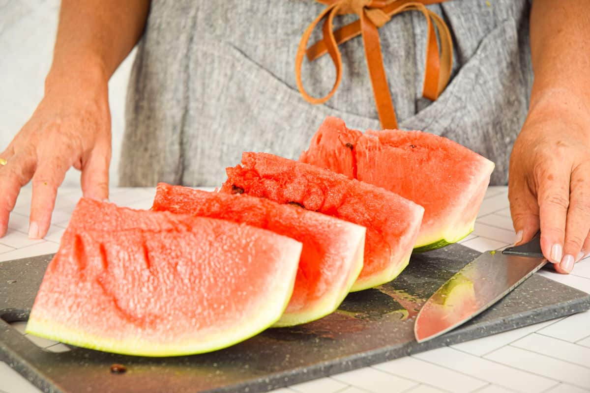 Watermelon wedges on cutting board.