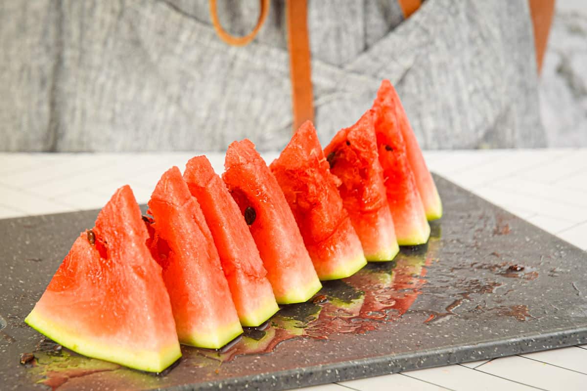 Watermelon triangles on cutting board.