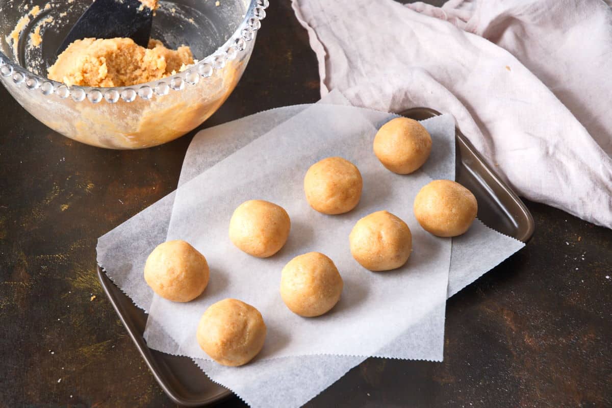 Cake pop balls on parchment lined baking sheet.