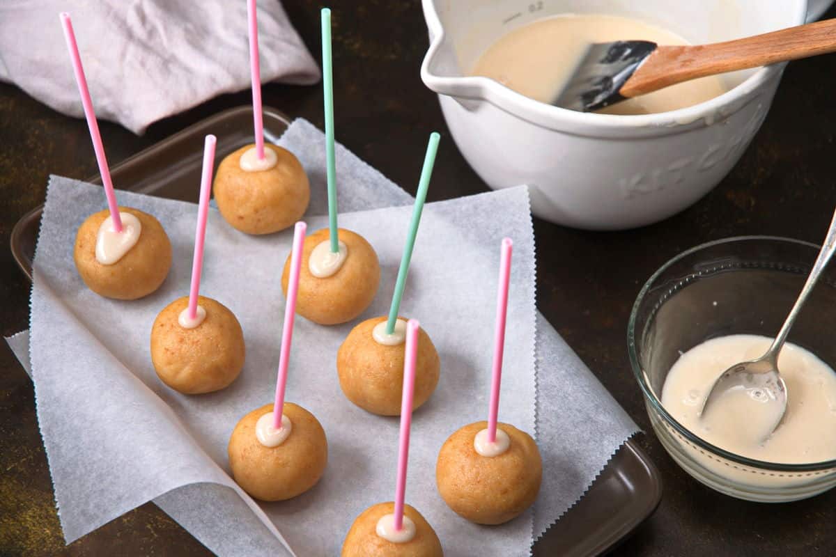 Cake pop balls with treat sticks inserted.
