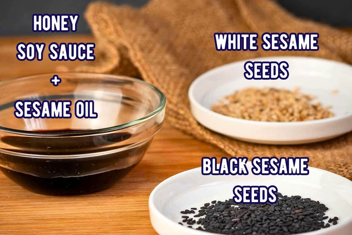 Honey soy marinade and black and white sesame seeds in small bowls - labeled.