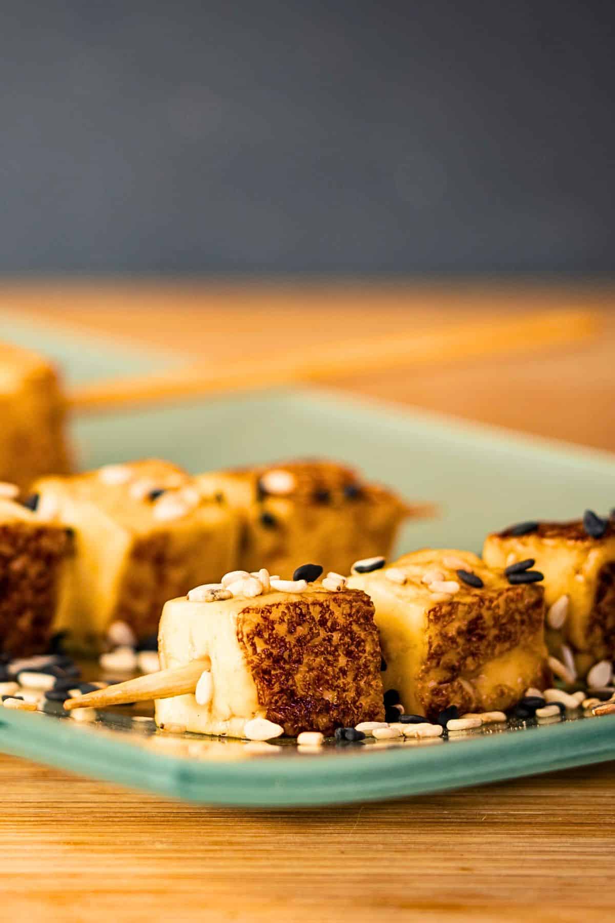 Fried tofu on serving plate.
