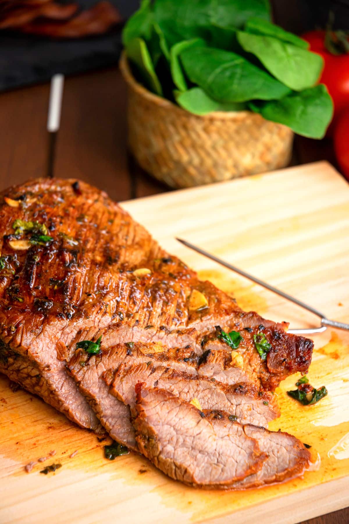 Carne asada sliced into thin strips on cutting board.