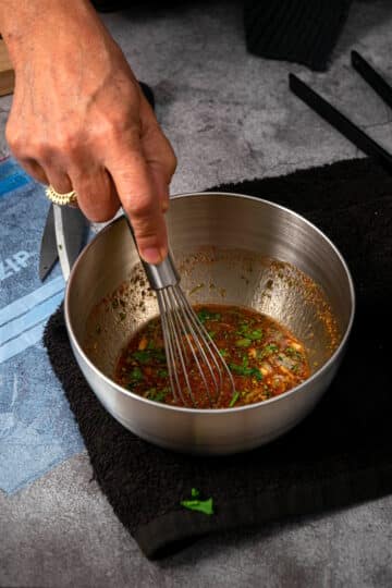 Steak marinade whisked in bowl.