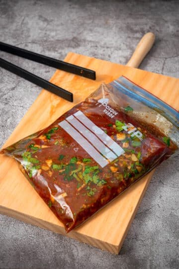 Flank steak marinating in zip-top bag.