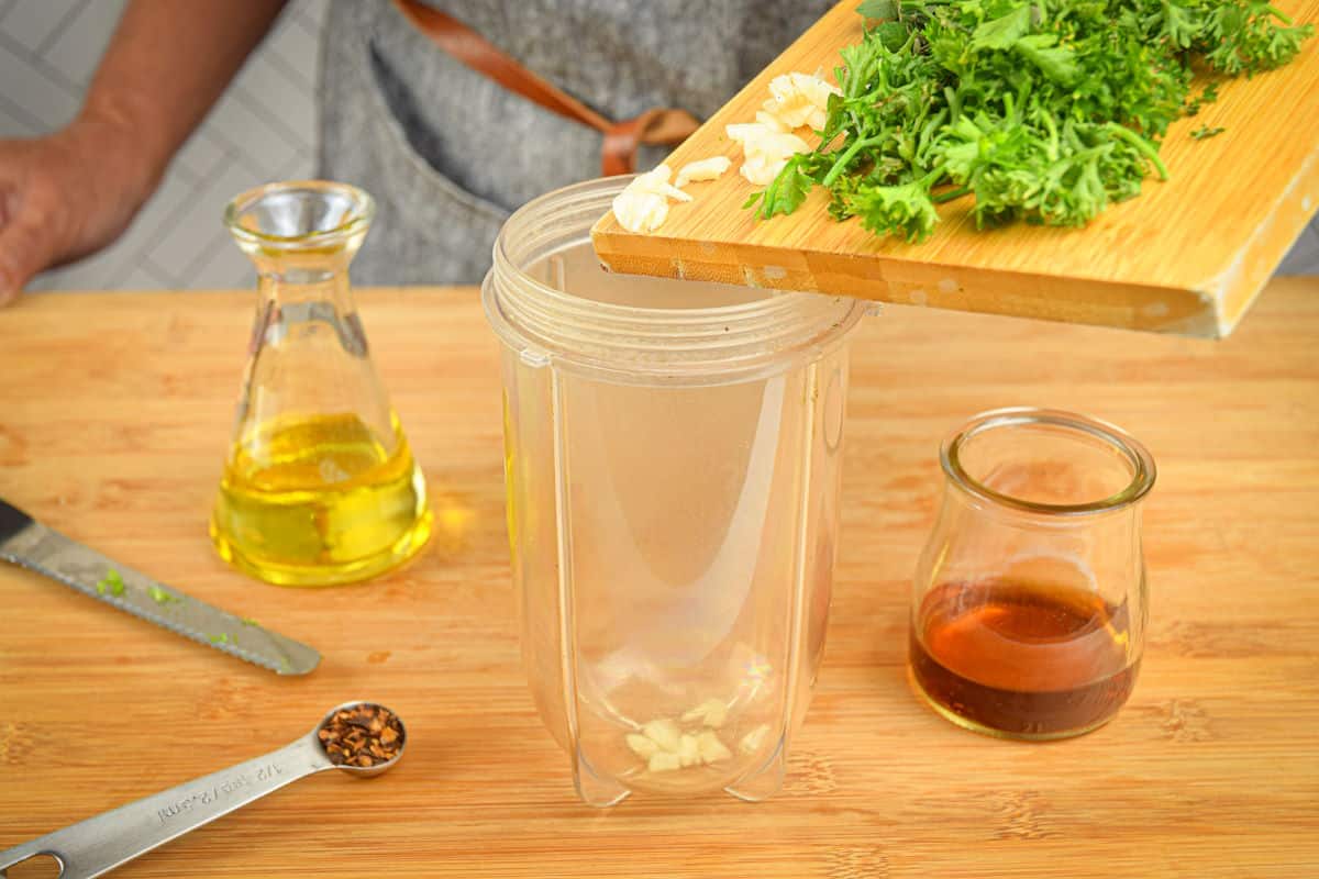 Chimichurri sauce ingredients in blender jar.
