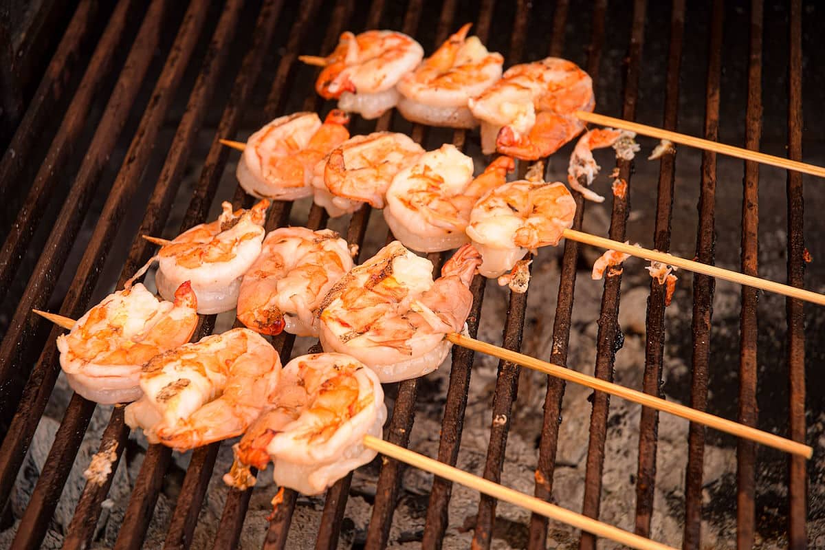 Jumbo shrimp skewers on outdoor grill.