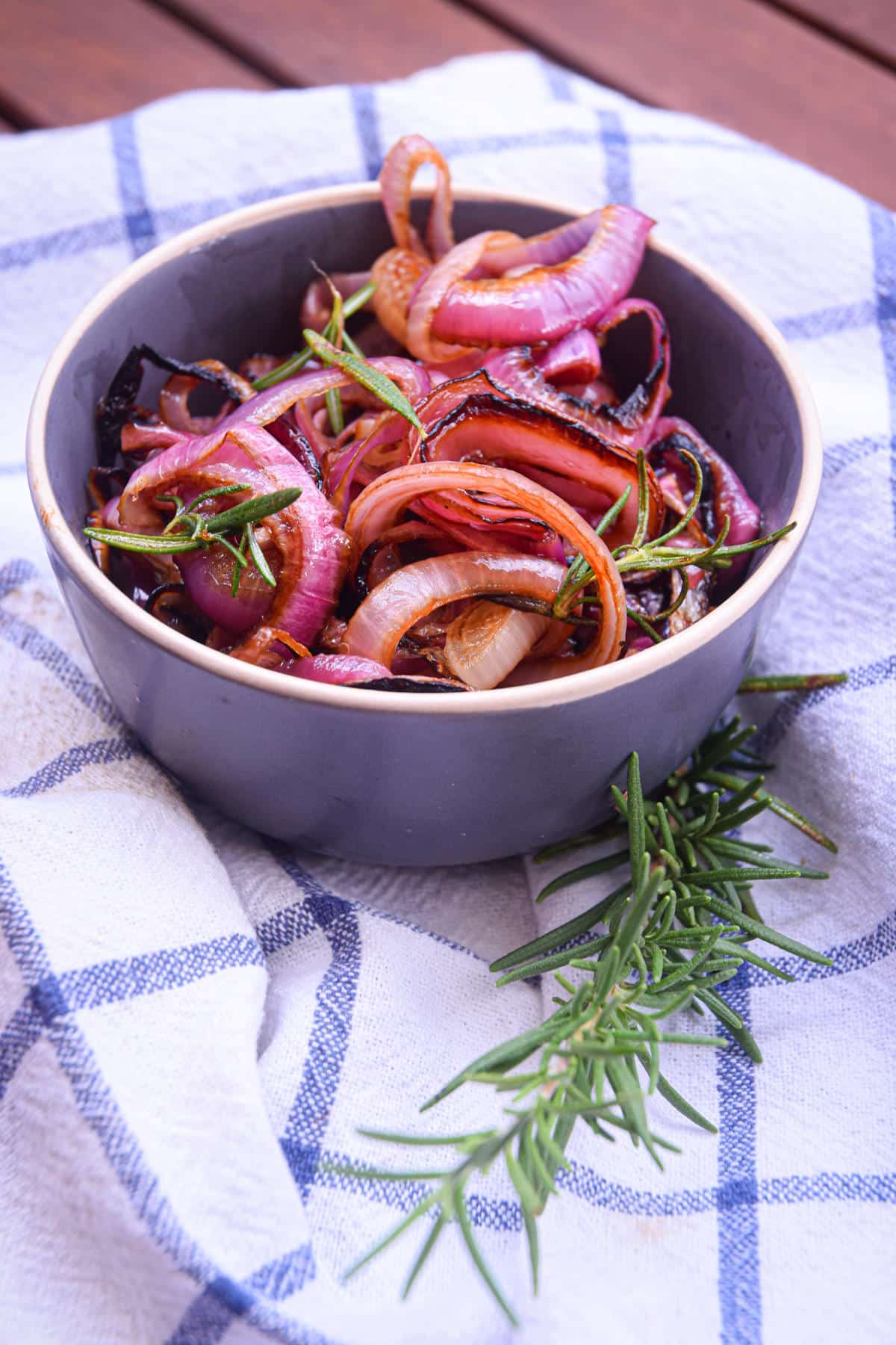 Grilled red onion rings in bowl.