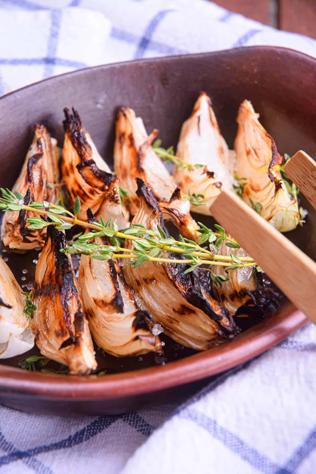 Grilled onion wedges in dish.