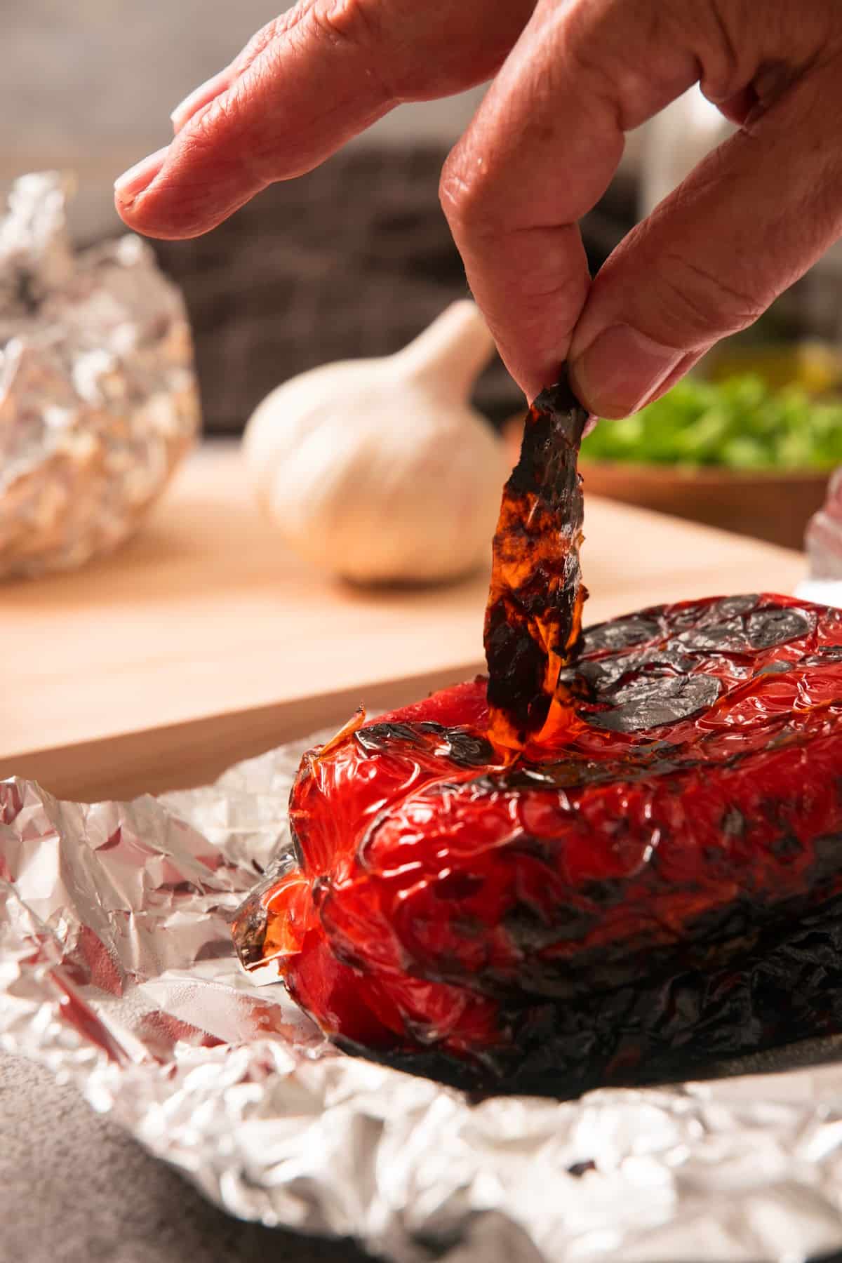 Red bell pepper getting the skin peeled off.