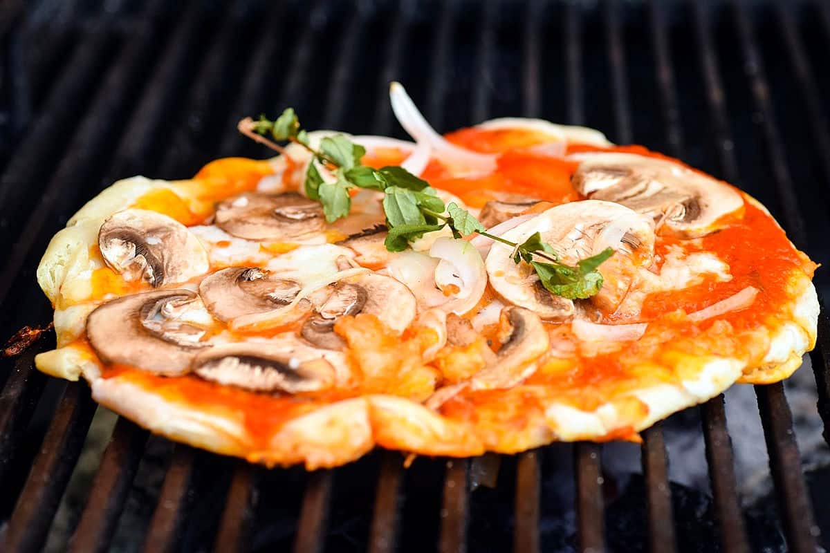 Pizza grilling on the outdoor barbecue.