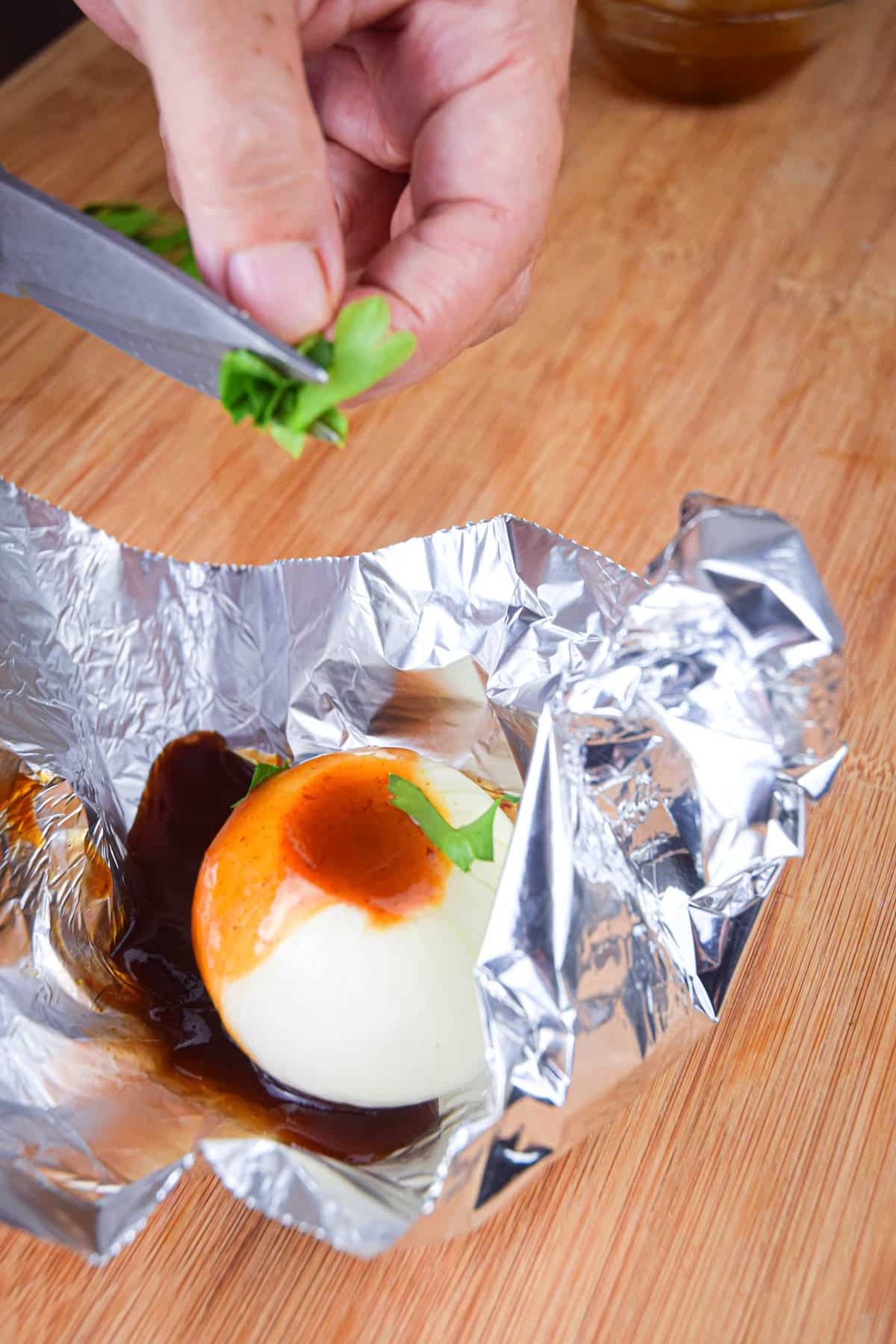 Onion and BBQ sauce on foil sheet.