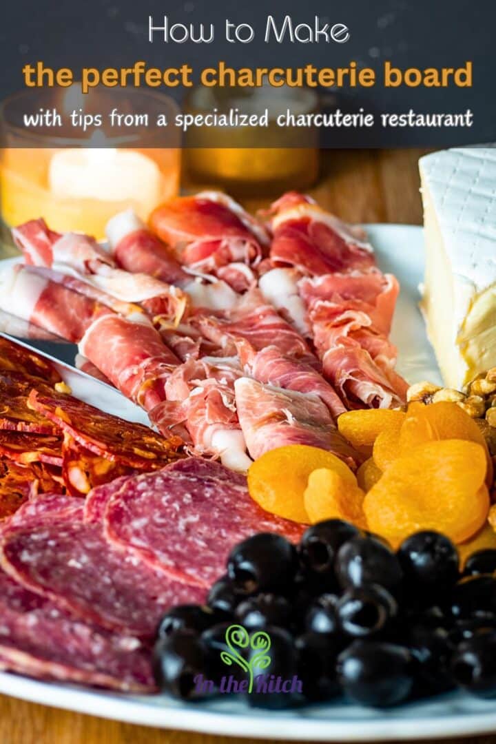 Circular charcuterie board with meat, cheese, breadsticks, nuts, apricots and olives.