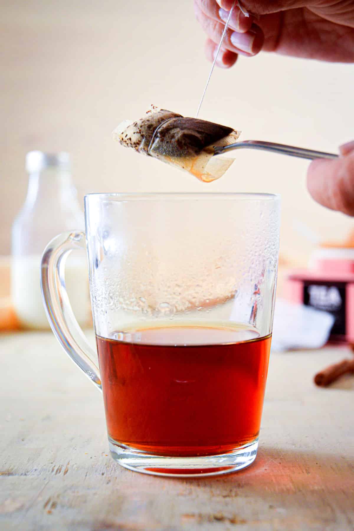 A clear glass mug with Earl Grey tea.
