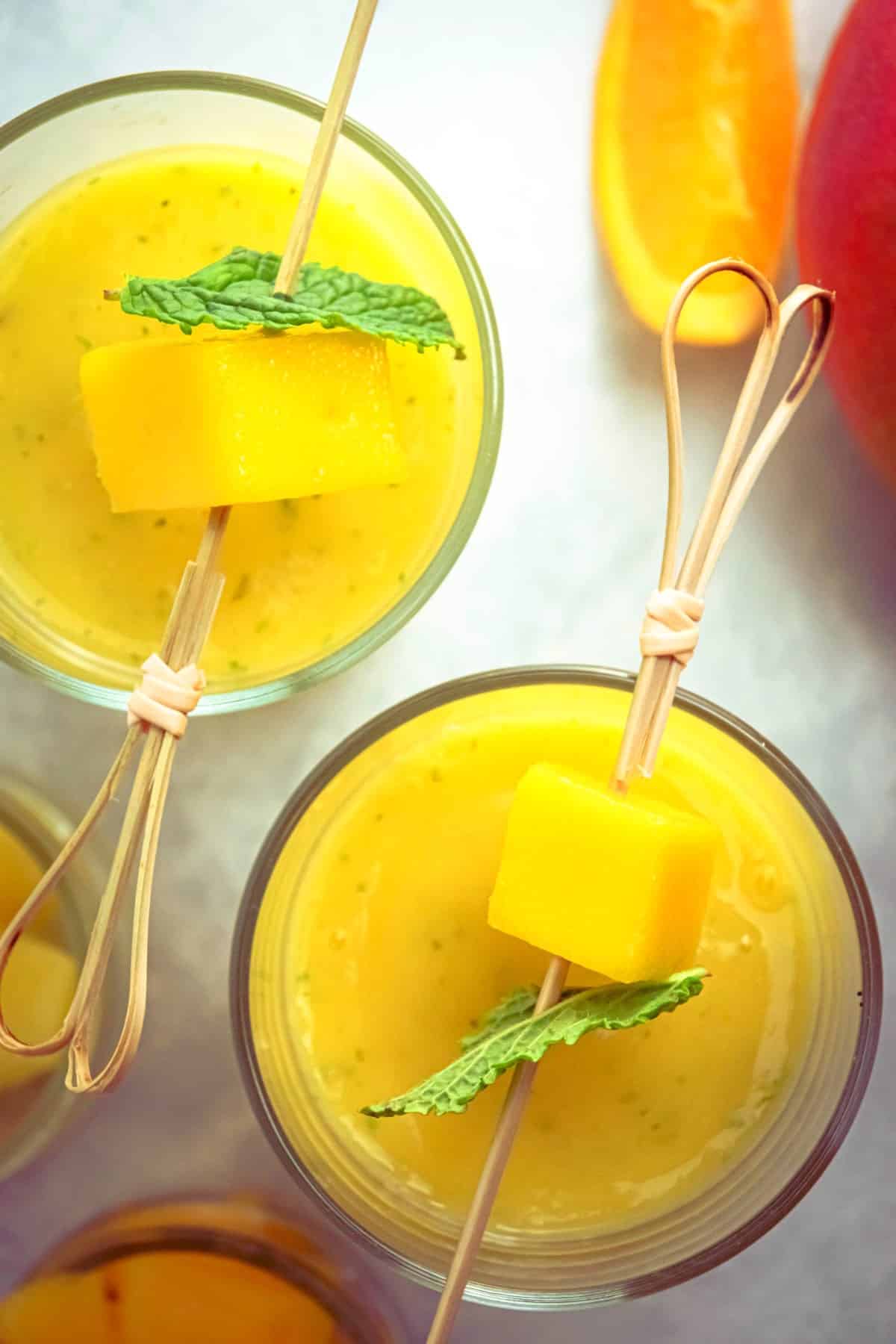 Mango pineapple smoothie in glasses.
