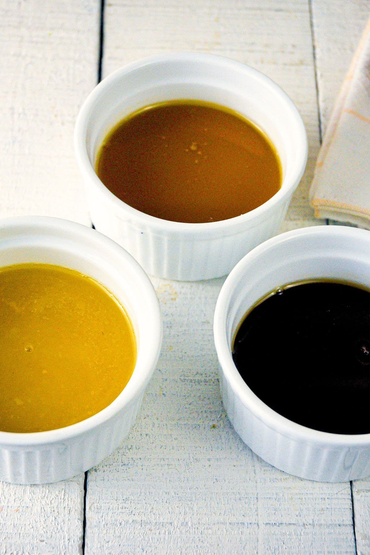 3 colors of roux in small, white ramekins.