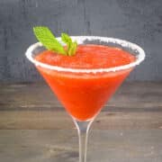 Strawberry slushy margarita with mint leaves.