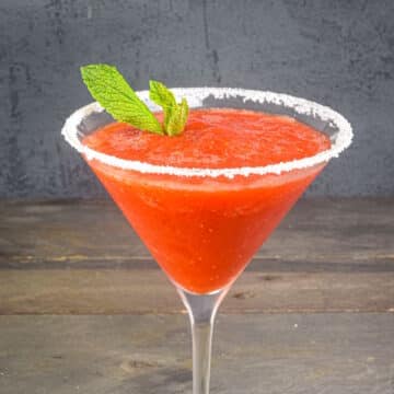 Strawberry slushy margarita with mint leaves.