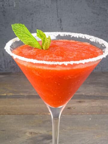 Strawberry slushy margarita with mint leaves.